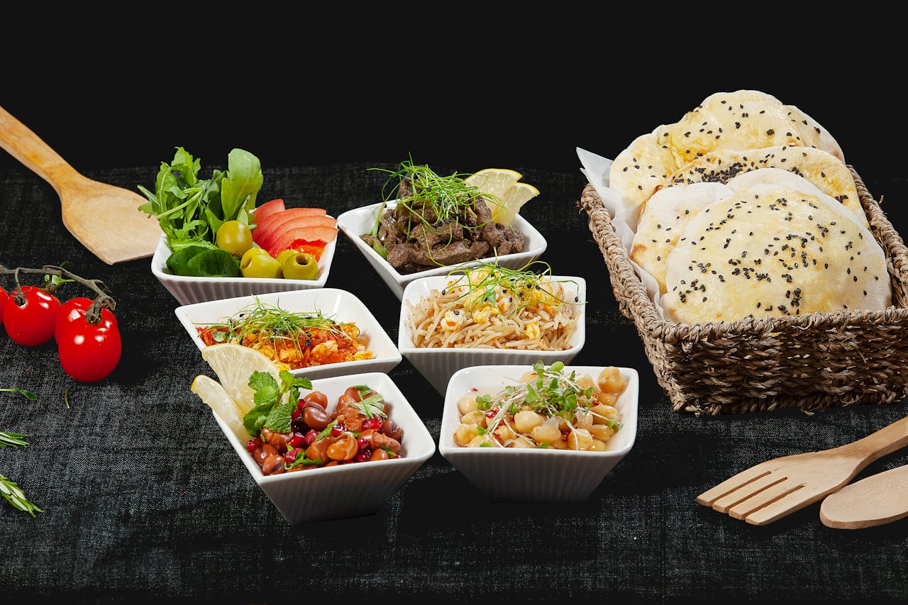 A vibrant mezze platter with Middle Eastern dishes and fresh bread, perfect for sharing.